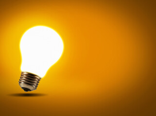 Energy, inspiration and lightbulb with a glow, innovation and science against studio background. Light, knowledge or enlightenment with ideas, growth and development with solution and problem solving