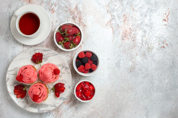 top view pink strawberry cakes with cup of tea on white background fruit sugar berry cake biscuit...
