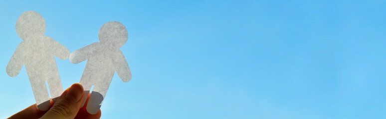 man from white paper on blue sky background. World Day of Peace. Day Against Humiliation....