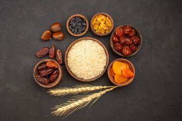 top view raw rice with different raisins on a grey background rice raw meal food granule
