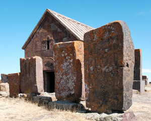 Old khachkars and small church of Noratus Cemetery on sunny summer day. Noratus village,...