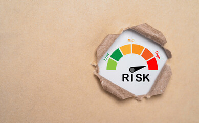 Risk level indicator rating inside punch brown paper from low to high on for business risk...