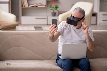 Old man enjoying virtual glasses at home