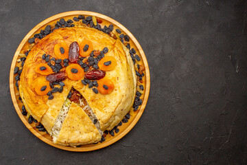 top view shakh plov delicious rice meal cooked inside round dough with raisins on the grey...