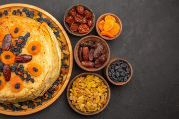 top view tasty shakh plov cooked rice inside round dough with raisins on grey desk dough rice meal cooking cuisine