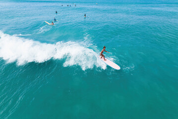 Black female surfer riding a wave