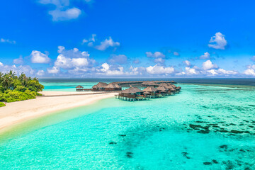 Beautiful Maldives paradise. Tropical aerial travel landscape, seascape with wooden bridge, water villas, amazing sea sand sky beach, tropical island nature. Exotic tourism destination summer vacation