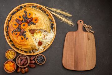 top view tasty shakh plov with raisins and dried apricots on grey background rice dinner meal...