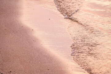 Soft wave of the sea on the sandy beach.