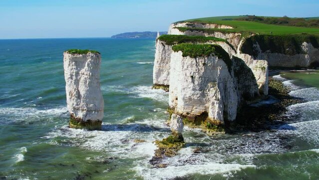 Aerial shot of Old Harry Rocks and coastline with rough seas, Dorset, UK