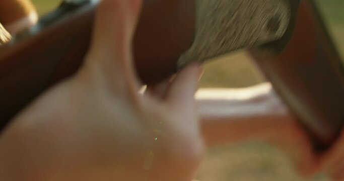 Process of loading shotshell into hunting double-barreled rifle slow motion preparation for shooting Autumn hunting season. Outdoor sports. Woman hunter in the woods - detail of the rifle being loaded