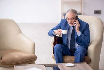 Old businessman waiting for business meeting