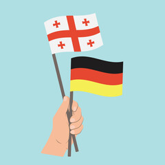 Flags of Georgia and Germany, Hand Holding flags