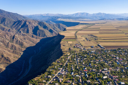 Armenian rural landscape. Aerial view of Odzun village, farmlands and Debed Gorge on sunny summer day. Lori Province, Armenia.