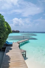 Fotobehang Amazing drone view of the beach and water with beautiful colors. Paradise scenery water villas with amazing sea and beach, tropical nature. summer vacation. © PimPhoto