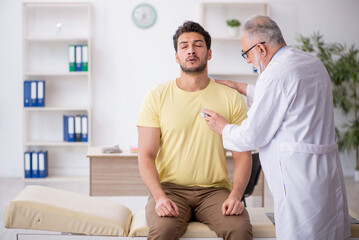 Young male patient visiting old male doctor