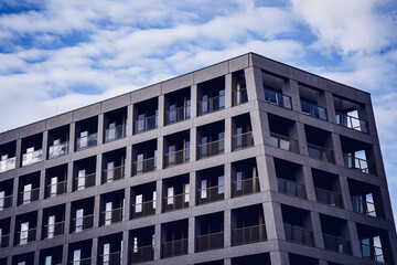 Modern building with glass facade at the clear sky background