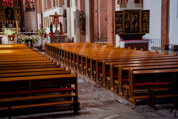 Fototapeta na wymiar Rows of church benches at the old european catholic church.