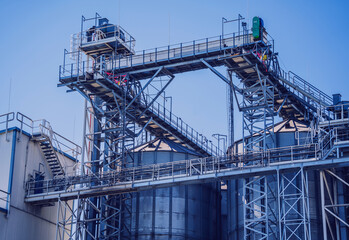 Modern silos for storing grain harvest at the blue sky background.