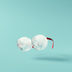 Ice cube eyeglasses on blue background. Creative summer. Minimal idea concept. 3d rendering