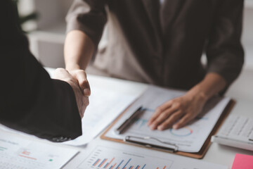 Business investor group handshake, Two businessmen are agreeing on business together and shaking hands after a successful negotiation. Handshaking is a Western greeting or congratulation.