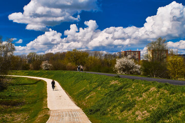 Fototapeta na wymiar path in the park with cloudy sky, bicycle path