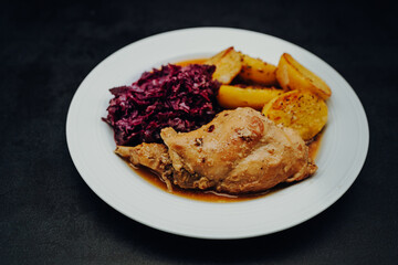 Rabbit leg with potatoes and red cabbage, classic Easter meal