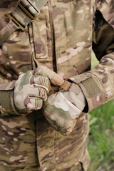 Preparing for Action: Close-up of Camouflaged Tactical Gloves being Fastened