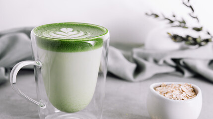 glass cup of fresh matcha latte and oatmeal