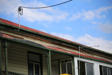 old rusty roof building with wire connection and antenna 