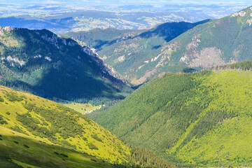 A view from the Wołowiec (Volovec) peak in the main ridge of the Western Tatras to the Chochołowska Valley (and Polana Chochołowska) on a sunny summer day. © IwoiWo