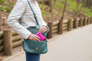 woman pulling purse out of her bag