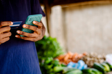 cropped close-up of a young man selling and purchasing online using mobile phone