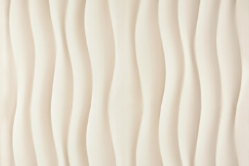 beige or ivory textured background with vertical waves, sandy smooth curved lines background.