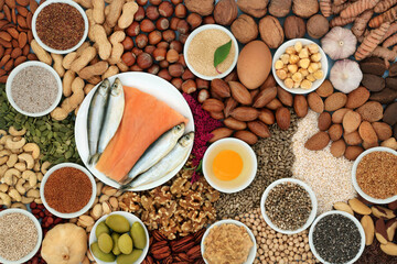 Healthy heart food ingredients high in lipids containing unsaturated good fats for low cholesterol levels with nuts, seeds, dairy, fish, vegetables, legumes and grain. Top view. - 600095060