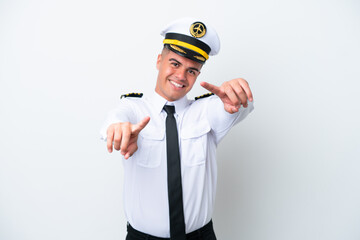 Airplane pilot caucasian man isolated on white background points finger at you while smiling