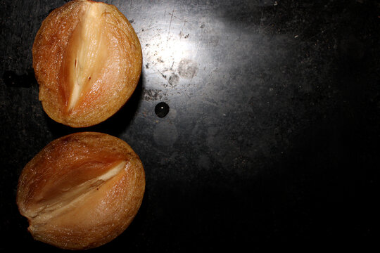 Manilkara Zapota Fruit Pieces with Black Background.
