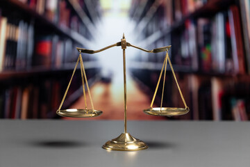 Shiny golden balanced scale in court library background as concept justice and fairness legal...
