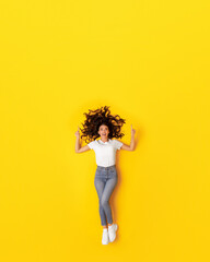 Fototapeta na wymiar Lady Pointing Fingers Up Advertising Offer On Yellow Background, Vertical