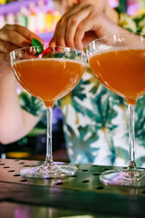man hand bartender making cocktail in glass on the bar counter