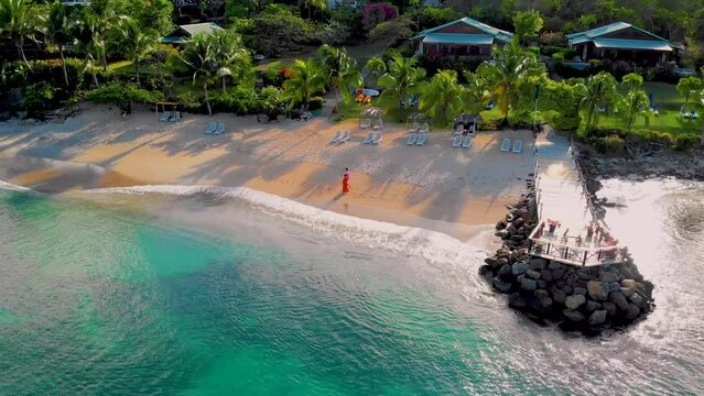 A couple of men and women walking on the beach at sunset at the beach of Saint Lucia Castries, St Lucia Tropical Island in the Caribbean
