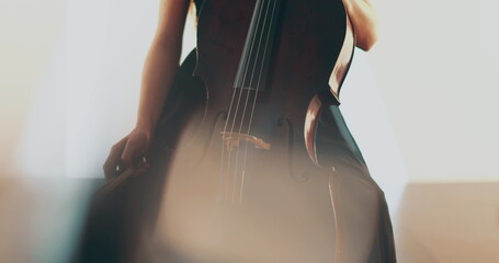 Single woman playing the cello, close-up and medium close-up, cello bow and strings, smooth...