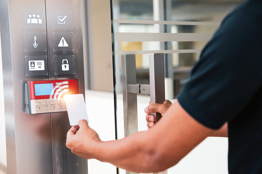 Proximity card reader door unlock, Hand security man using ID card on fingerprint scanning access control system for identity verification to open the door or for security safety or check attendance.
