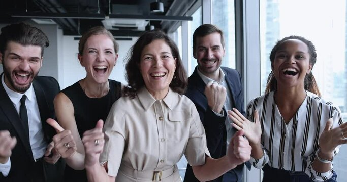 Group of happy millennial and mature employees celebrate professional success, gesturing feels overjoyed look at camera at workplace, got unbelievable opportunities, career or sales growth, promotion - Powered by Adobe