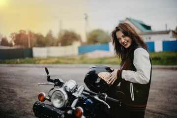 Obraz na płótnie Canvas beautiful woman motorcyclist on a vintage custom motorcycle. Woman biker