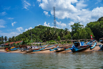 Obraz premium Local fishermen boats line up by the Kali Cokel or Cokel River, Pacitan. Indonesia.