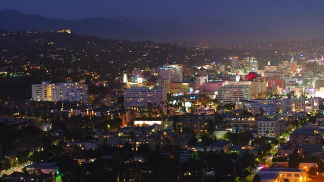 Aerial Forward Shot Of Illuminated Buildings In Residential District At Night - Los Angeles, California