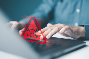 Businessman or It staff, Programmer or Developer using computer laptop with caution triangle skull...