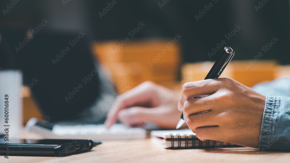 Aufkleber entrepreneur using a calculator to calculate numbers ,profit and loss statement review of company performance ,cost analysis ,financial paperwork ,business account checking ,Annual budget planning