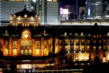 Fototapeta na wymiar 夜にライトアップされた東京駅の駅舎と丸の内の高層ビルと幻想的な夜景・デートスポット（東京都千代田区）